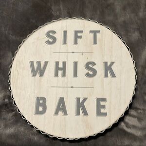 NWT’s- wooden round sign w/crinkled metal around wood. It says sift,whisk & bake
